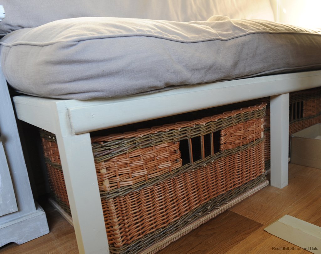 shepherd-hut-interior-under-sofabed-wicker-basket