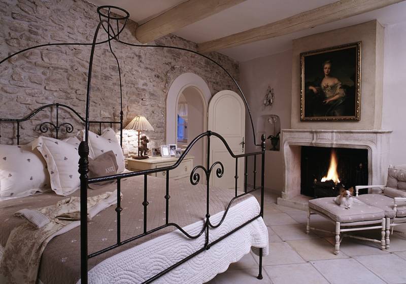 bedroom stone wall french fireplace neutral